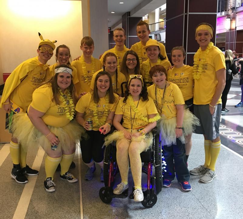 Band members pose with Avalon, the yellow team's Buckeyethon Kid. The team wore yellow because it is Avalon's favorite color.