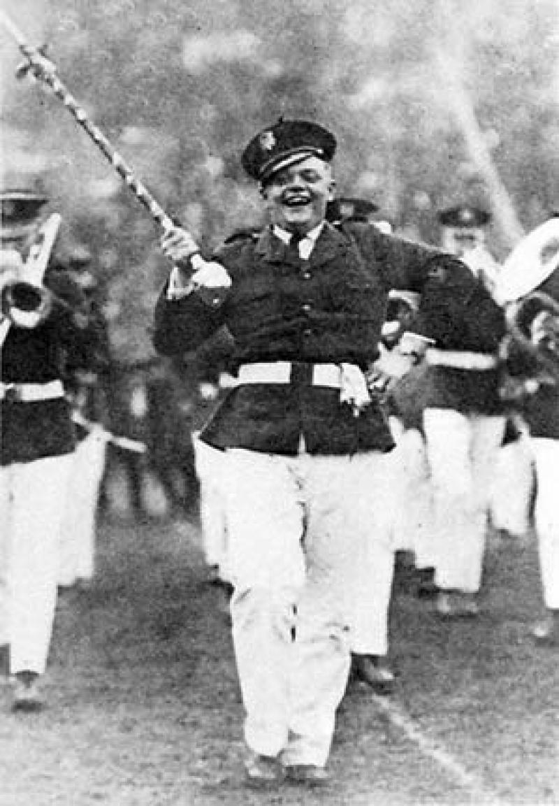 Drum Major George 'Tubby' Essington marching with the band.