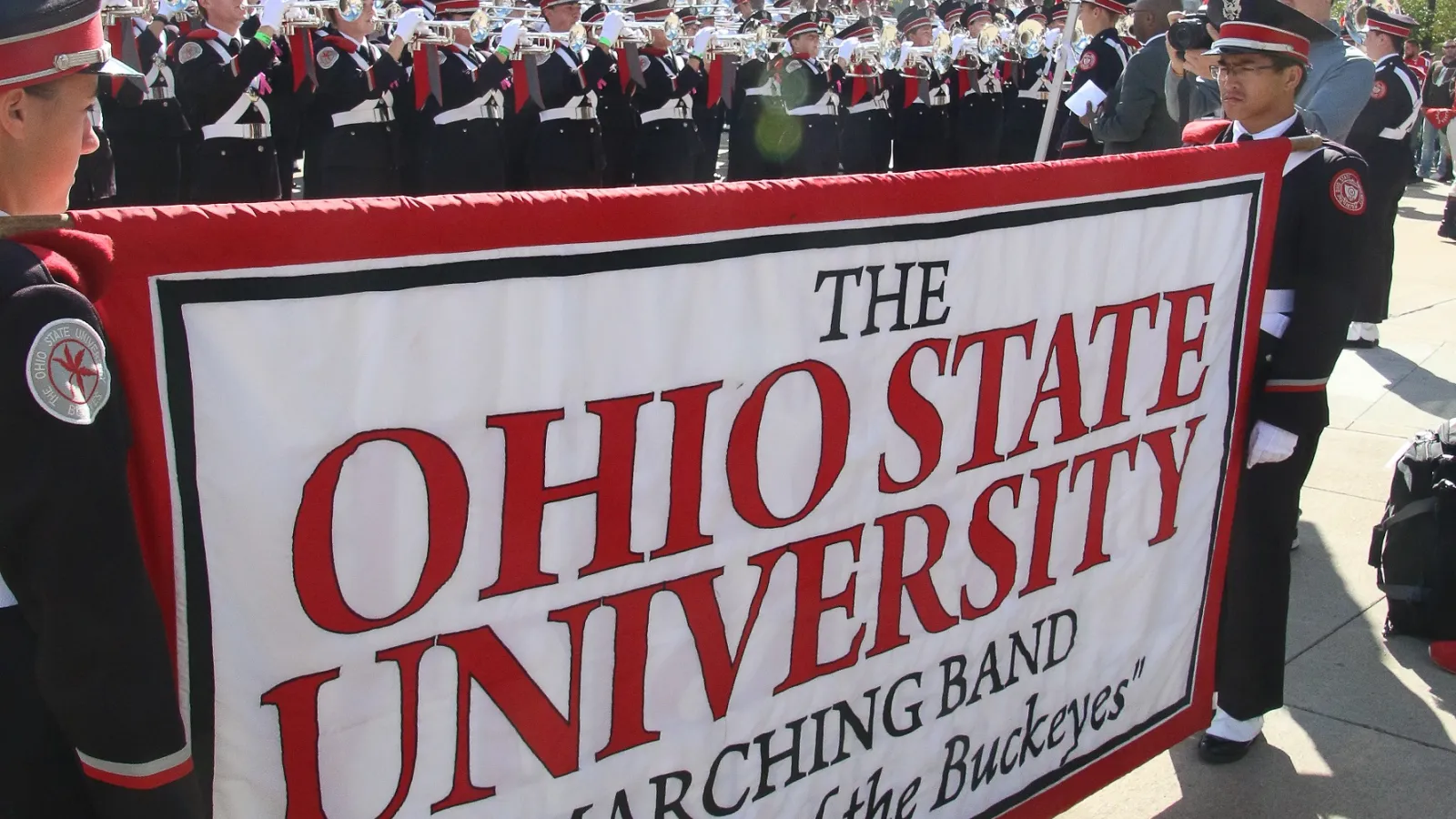 Photo of student staff holding banner