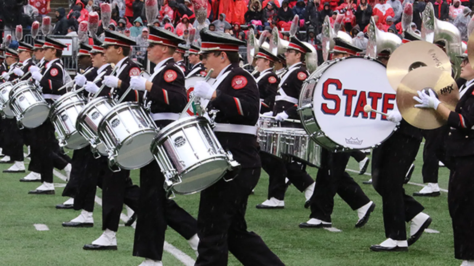 Members of the drumline march and perform