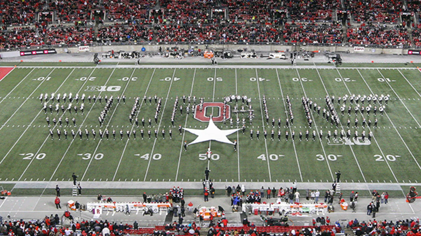 Marching band forms the Top Gun logo