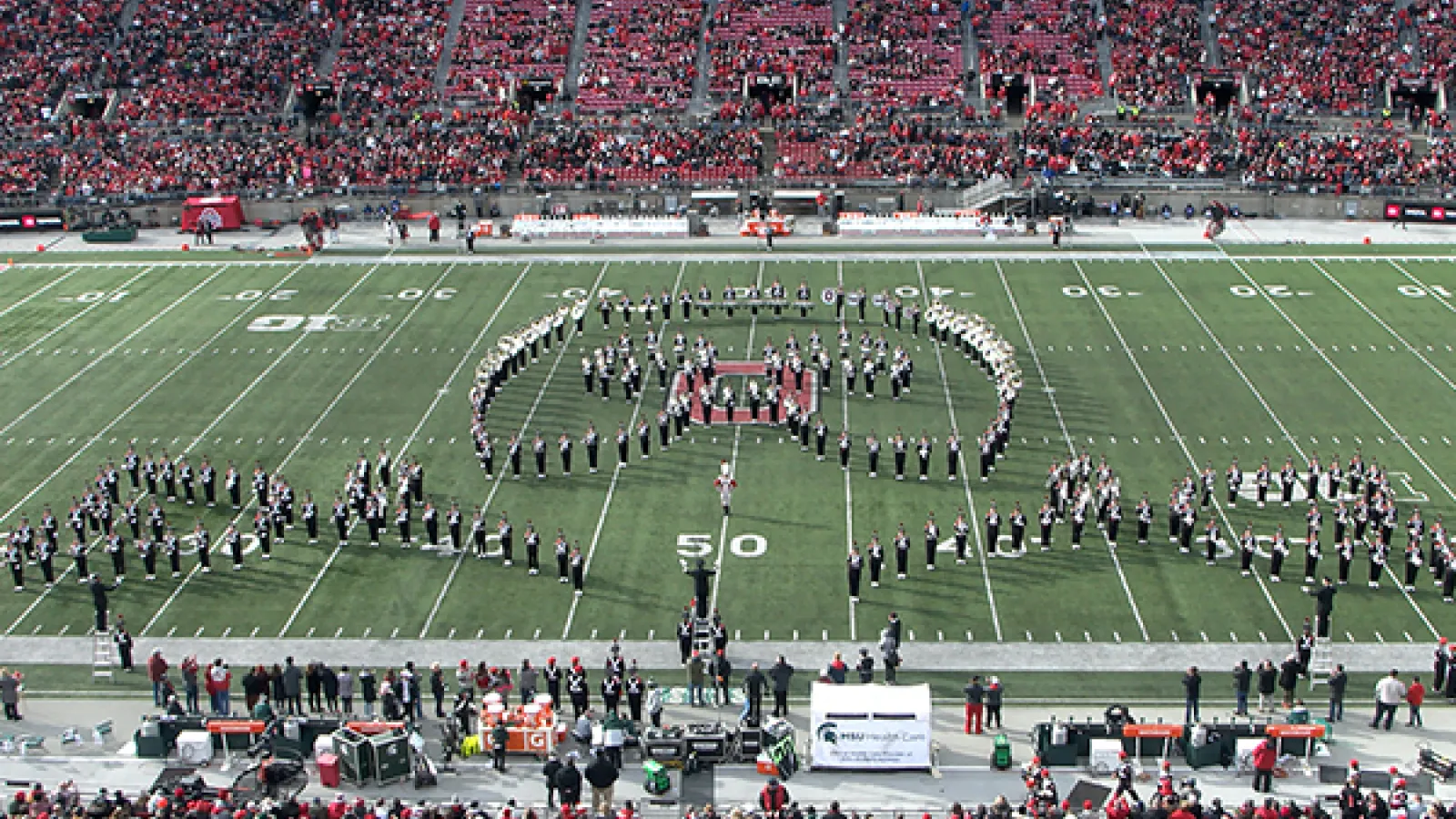 Marching band forming a mask and roses formation