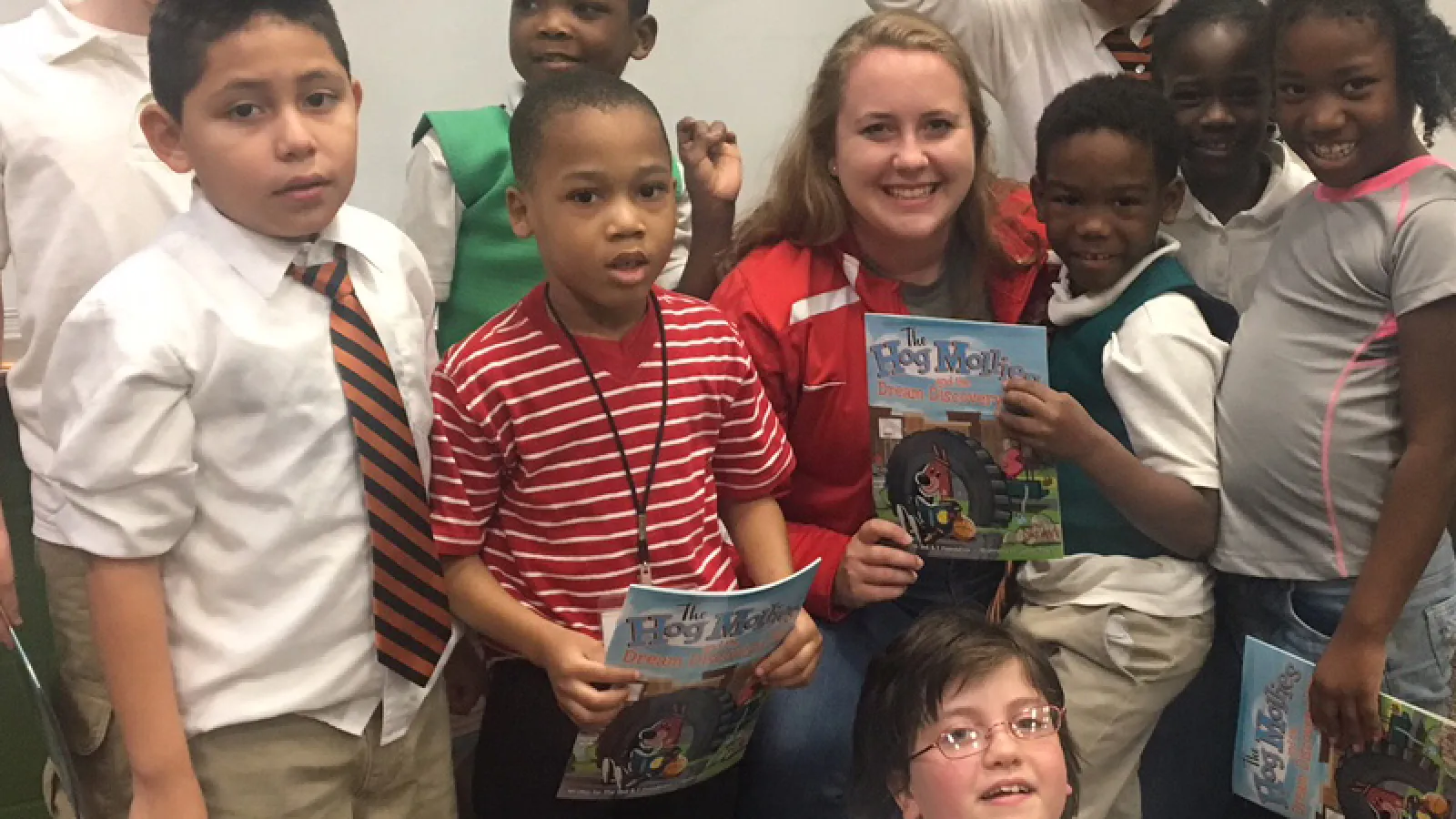Kelsey Crawford (center) poses with students after a reading