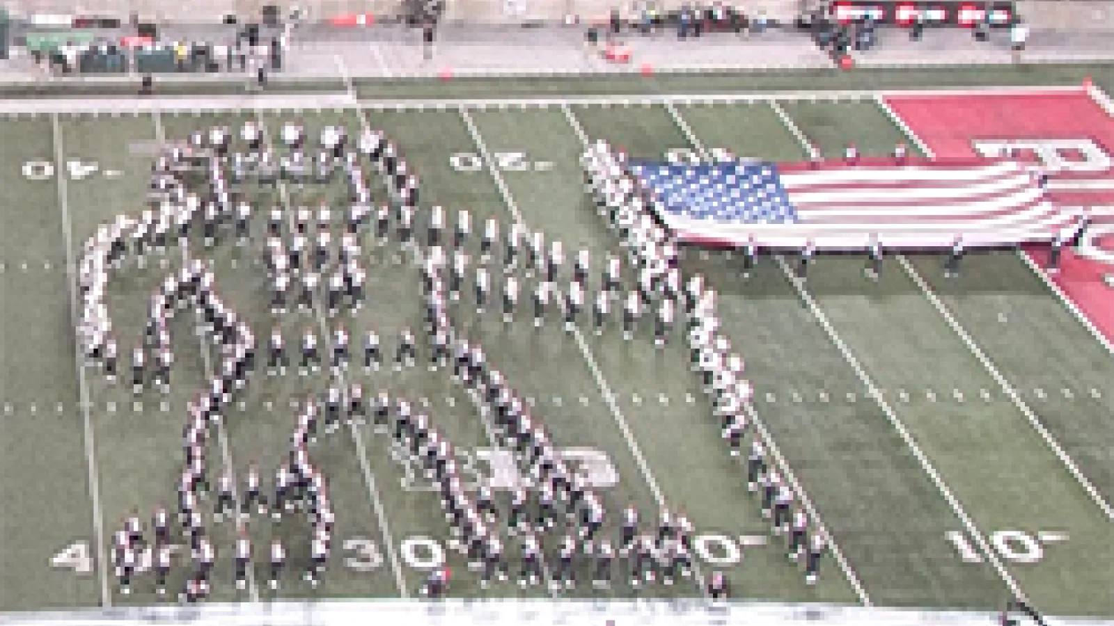 The band forms an astronaut planting the American Flag in the moon