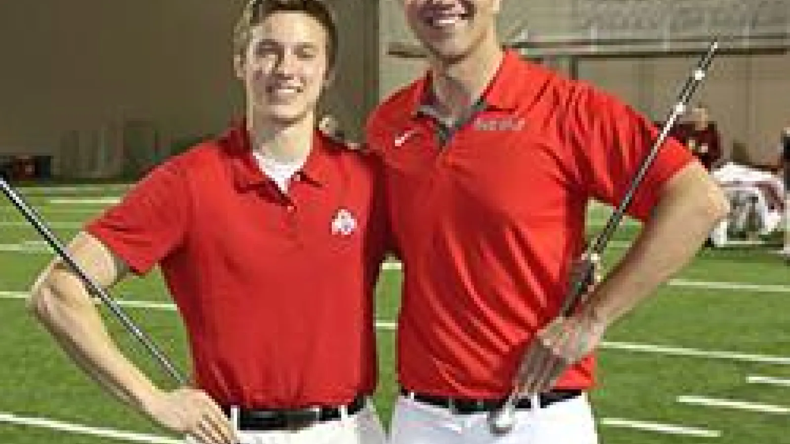 New drum majors pose with batons on the OSU practice field.