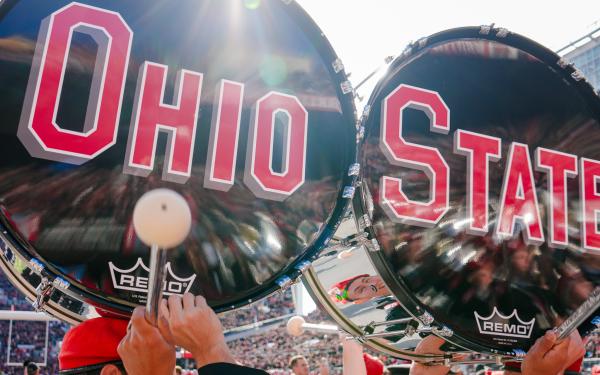 Ohio and State bass drums on heads of students
