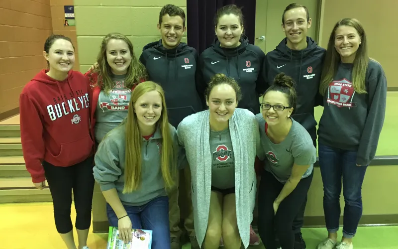 OSUMB members and Ohio State student-athletes pose for a picture