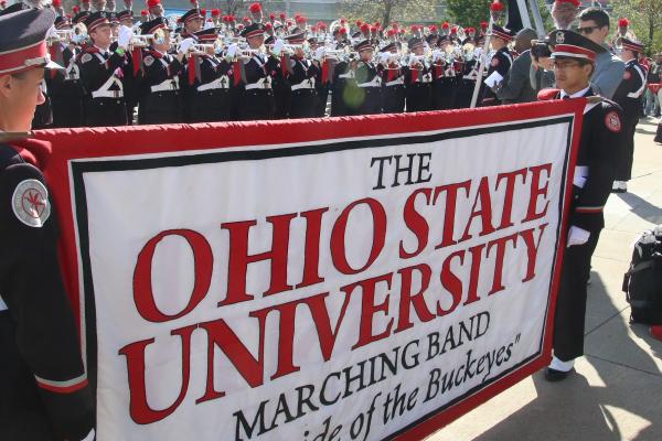 Student staff holding banner Photo of student staff holding banner