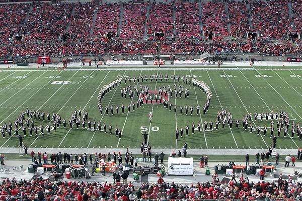 Marching band forming a mask and roses formation