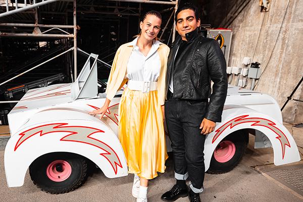 Marching band students performing in the "Grease" halftime show as Danny Zuko and Sandy Olsson