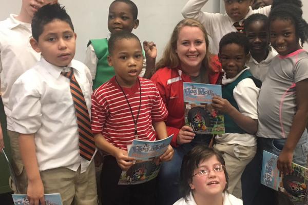 Kelsey Crawford (center) poses with students after a reading