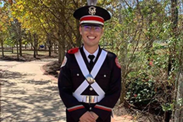 Christopher Lewis in marching band uniform