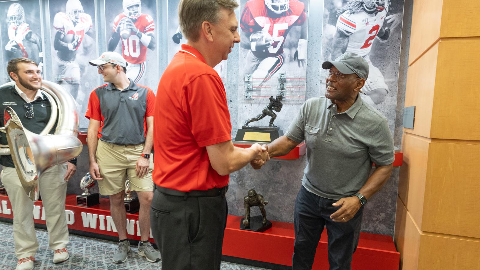 TBDBITL director Christopher Hoch shaking Archie Griffin's hand